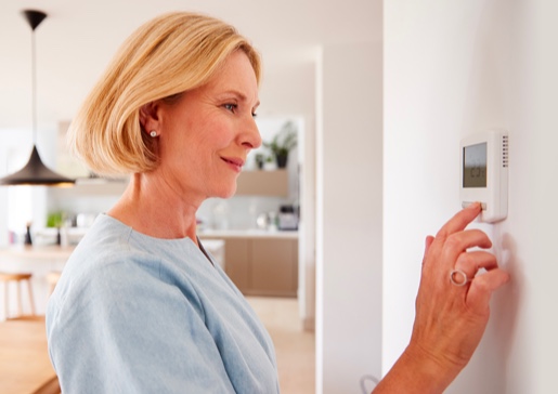 lady checking her thermostat